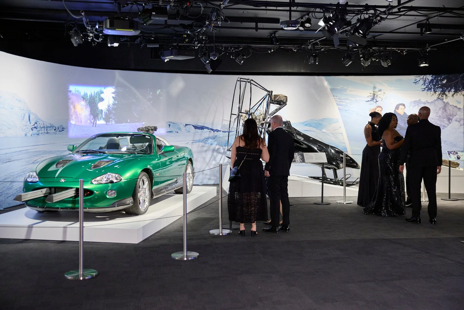 Bond-inspired green Jaguar and aircraft exhibit with guests