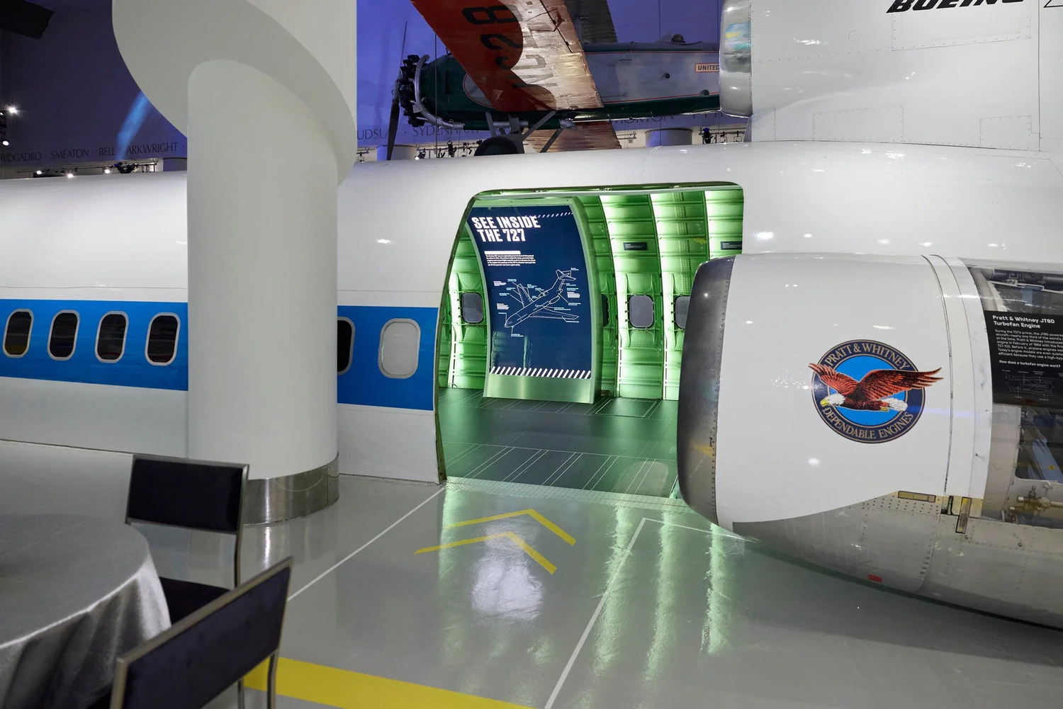 Boeing 727 fuselage exhibit beside event seating