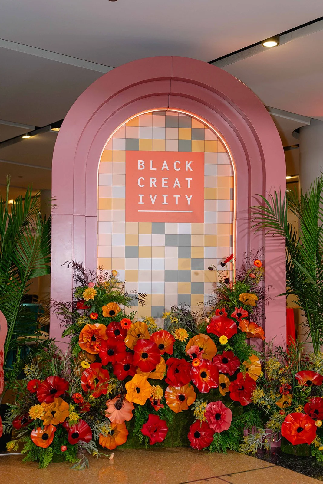 Pink arch photo moment with florals at the Black Creativity Gala