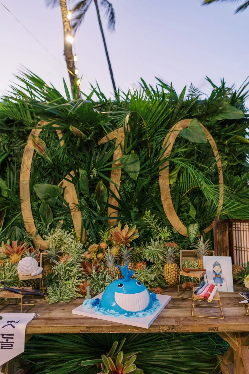 GIO tropical backdrop with blue whale cake and ceremonial table