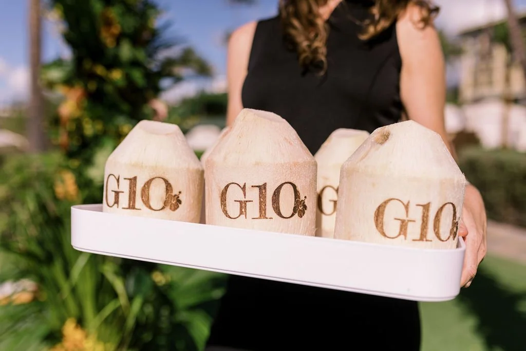 Custom branded G10 coconuts on a tray at Gio's celebration