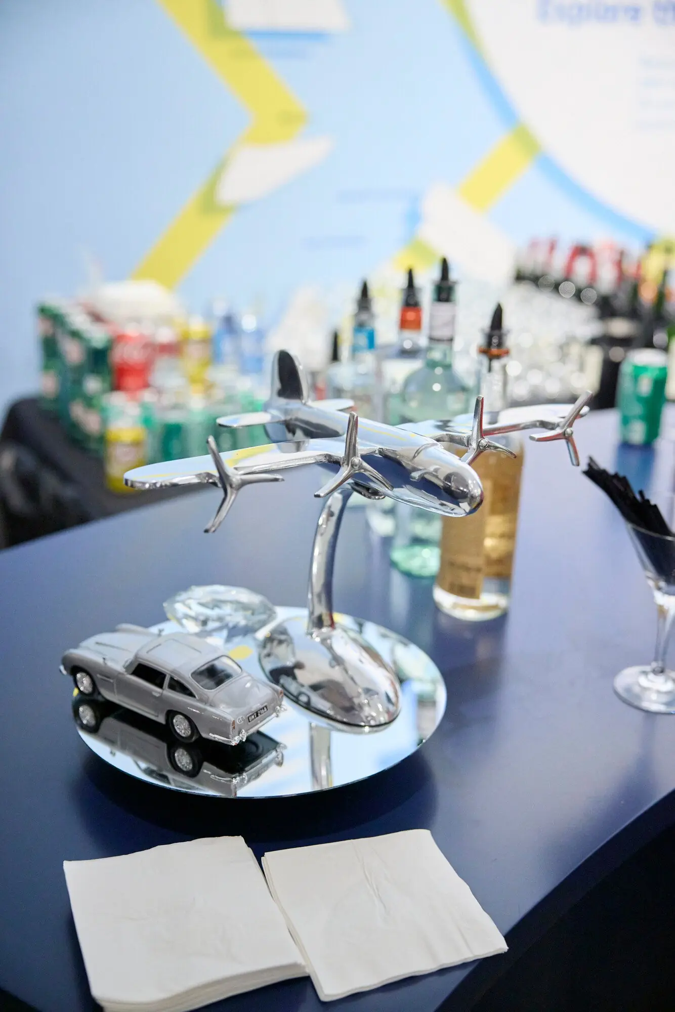 Chrome plane and Aston Martin bar décor for the 007 theme