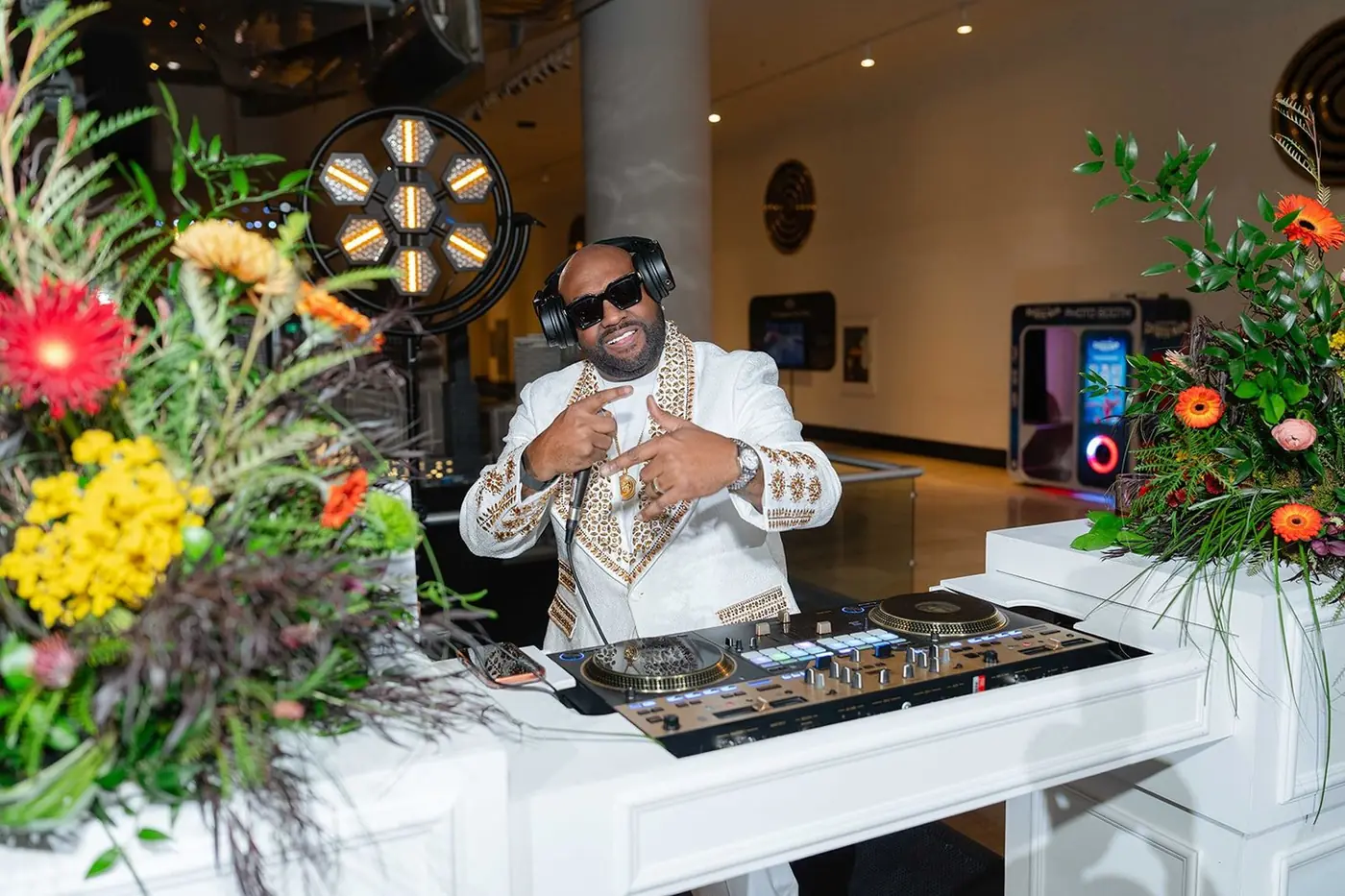 DJ at a floral-framed booth during the Black Creativity Gala