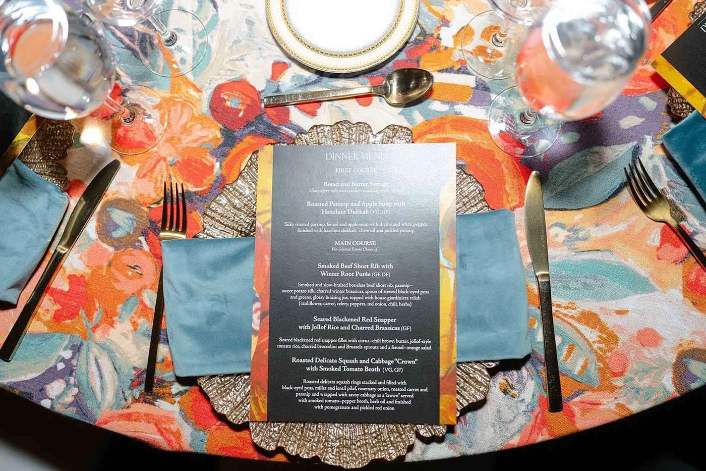 Dinner menu place setting on floral linen at the Black Creativity Gala