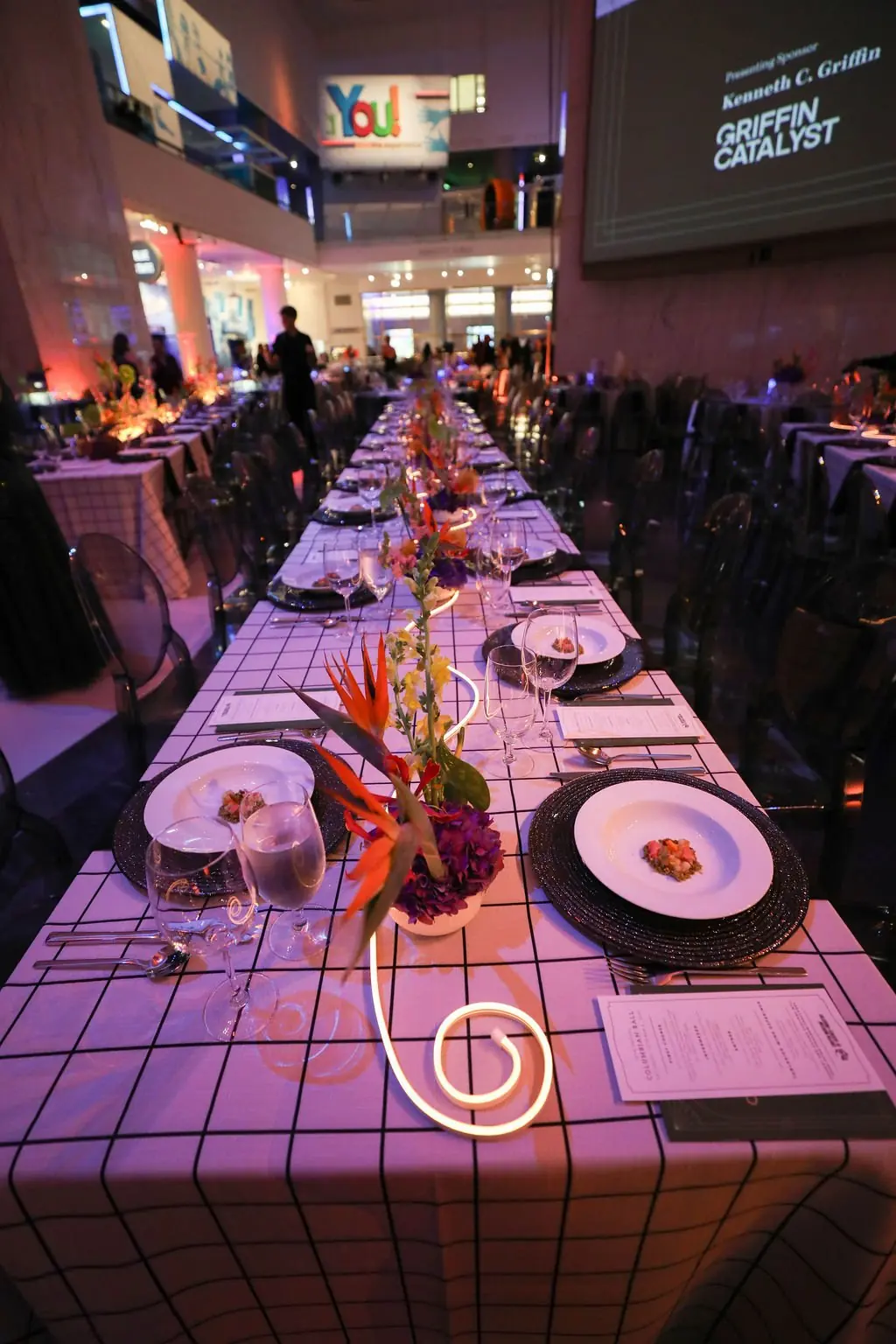Long grid-linen banquet table with LED runner at the Columbian Ball