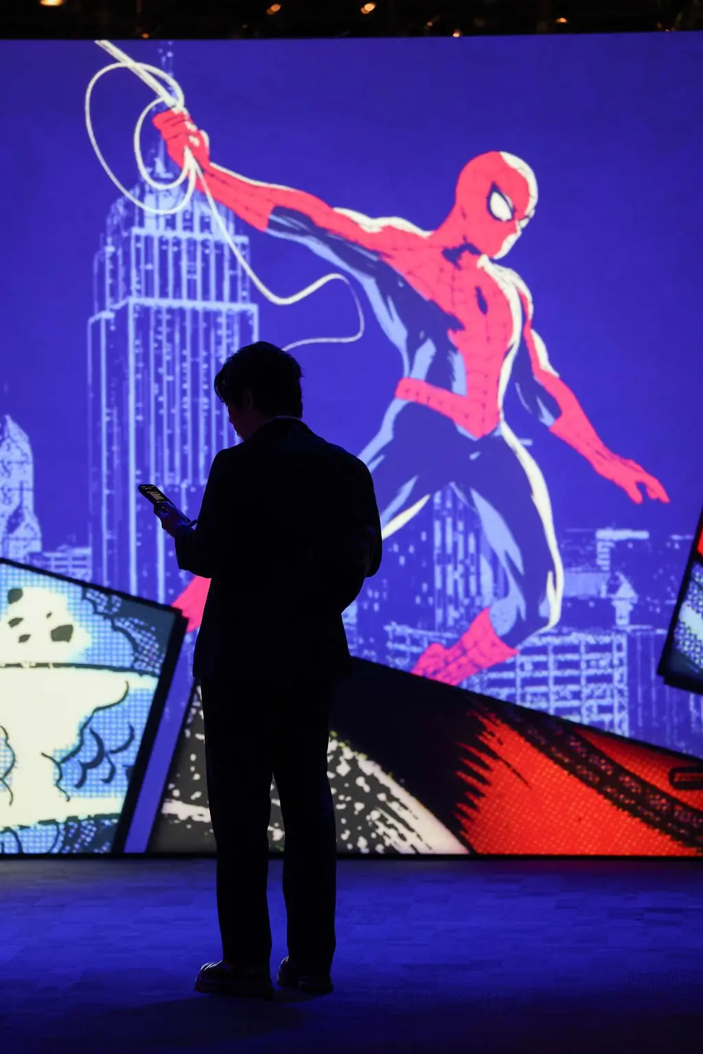 Silhouette against Spider-Man comic mural at the Columbian Ball