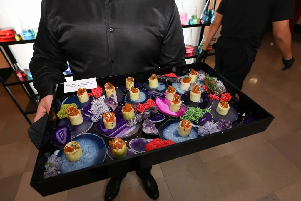 Geode-plated hors d'oeuvres tray with lab glassware backdrop