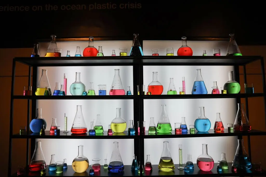 Backlit laboratory glassware shelving with colorful liquids