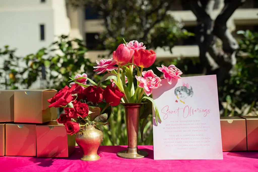 Sweet Offerings favor table with red roses on fuchsia linen