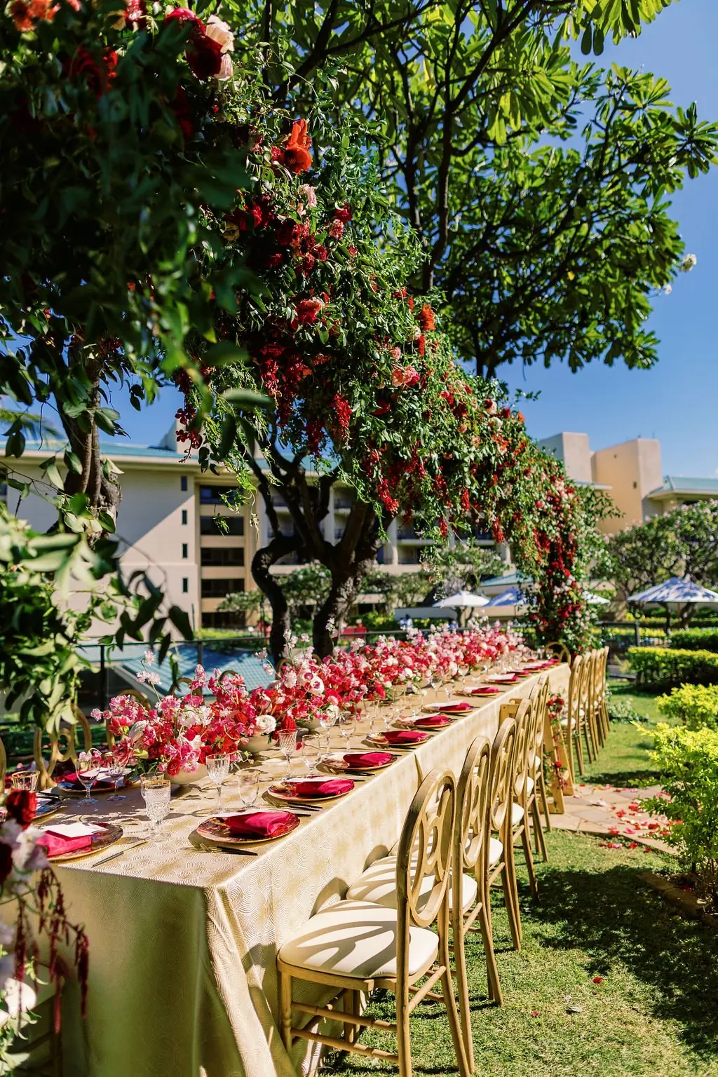 Outdoor Valentine's brunch table under a floral arch in the Plumeria Garden