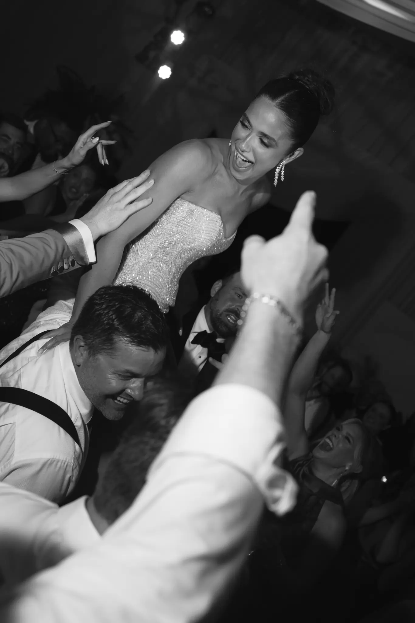 Black-and-white moment of the couple pressed together on a crowded dance floor at a Michigan Avenue Events wedding