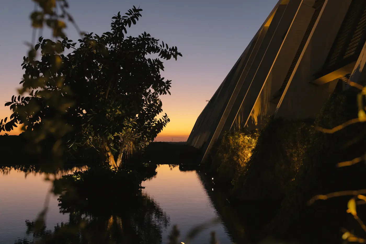 Night aerial of a lit resort and reflecting pool at dusk during a destination wedding planned by Michigan Avenue Events