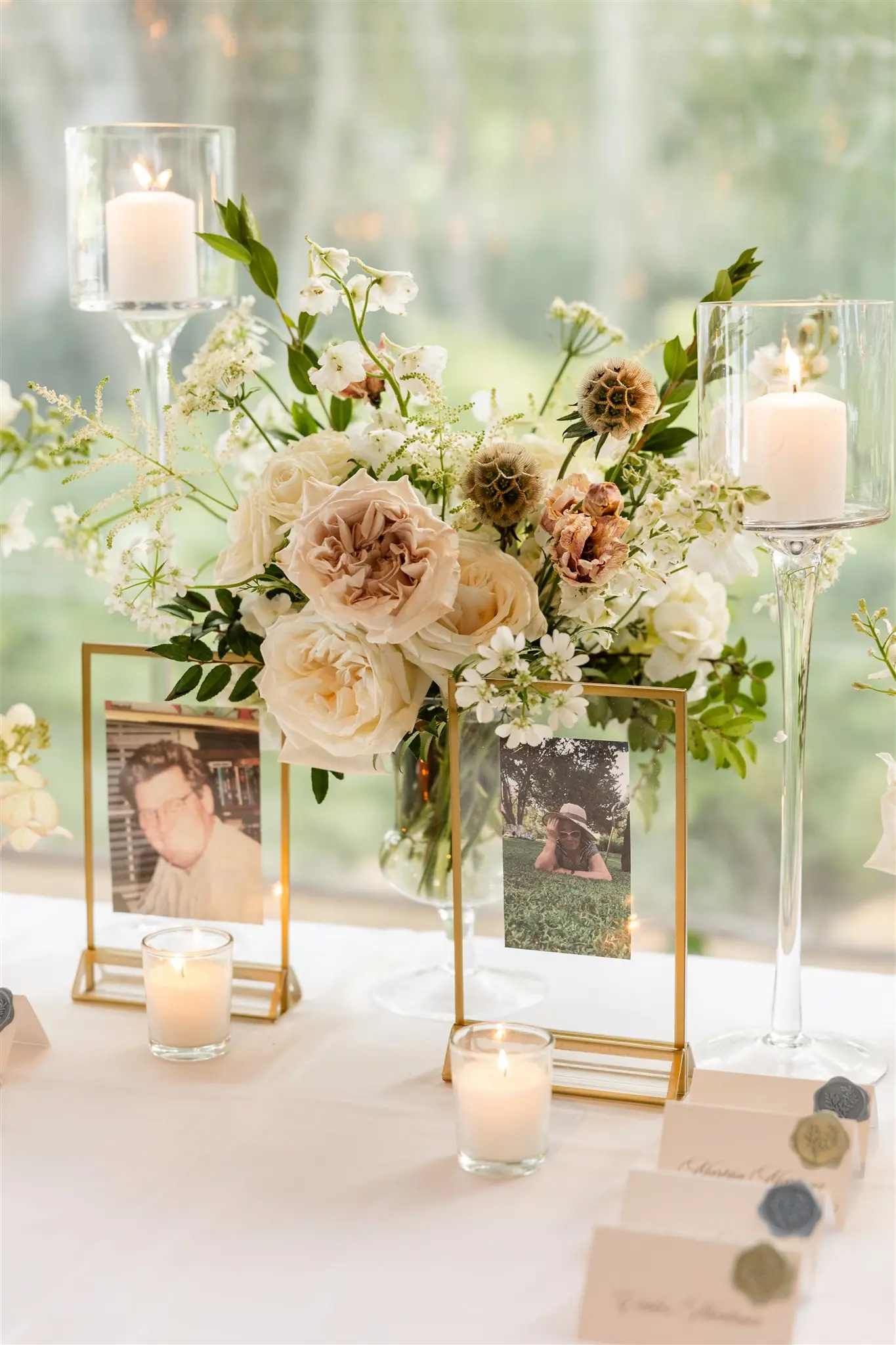 Blush florals and taper candles on a mirrored reception table at a wedding planned by Michigan Avenue Events