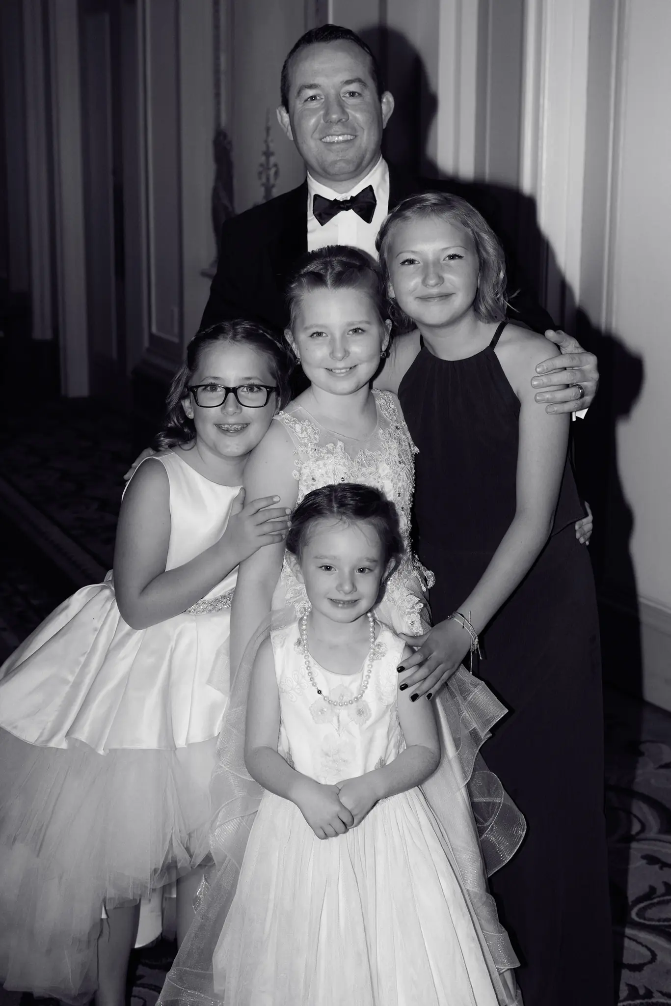 Black-and-white portrait of the couple with their flower girls at a wedding planned by Michigan Avenue Events