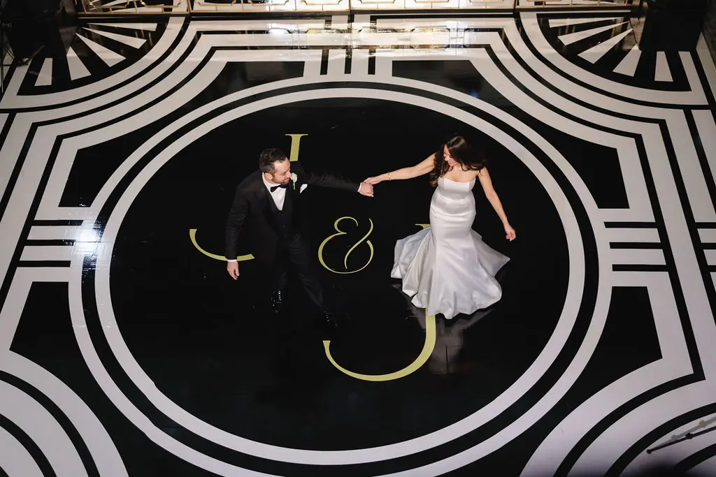 Black-and-white photo of the couple dancing on a monogrammed dance floor at a Michigan Avenue Events wedding