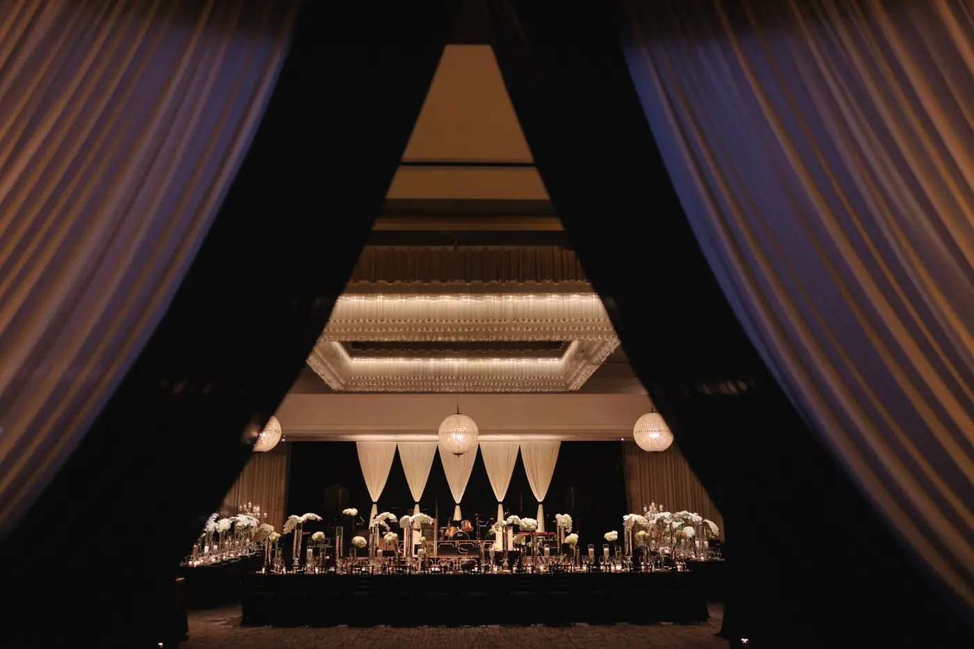 Black-and-white view of a draped ballroom ready for a reception planned by Michigan Avenue Events