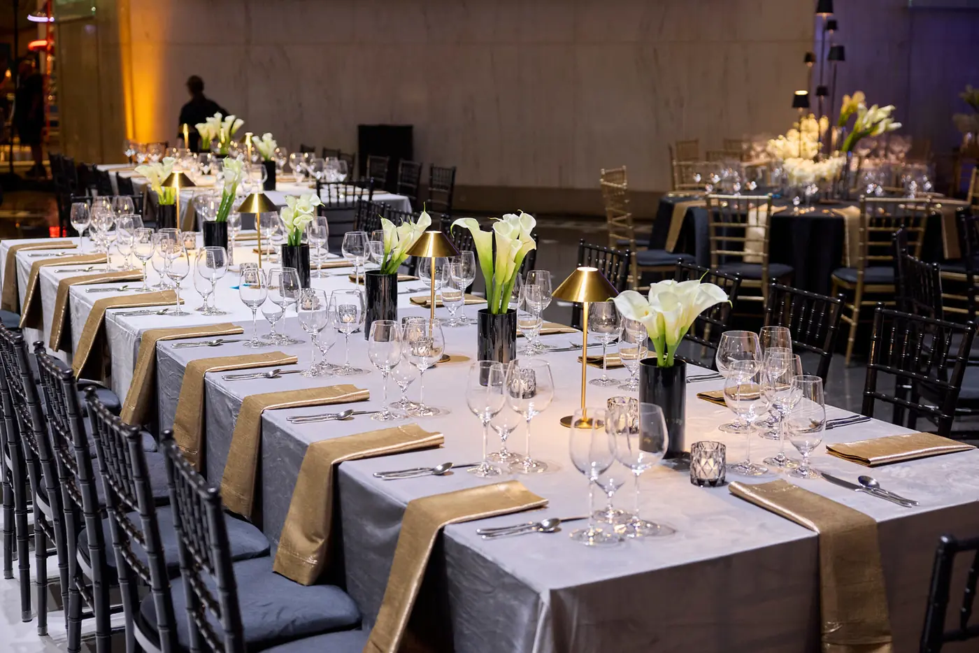 Long banquet table with black and gold place settings at the 007 Science gala produced by Michigan Avenue Events