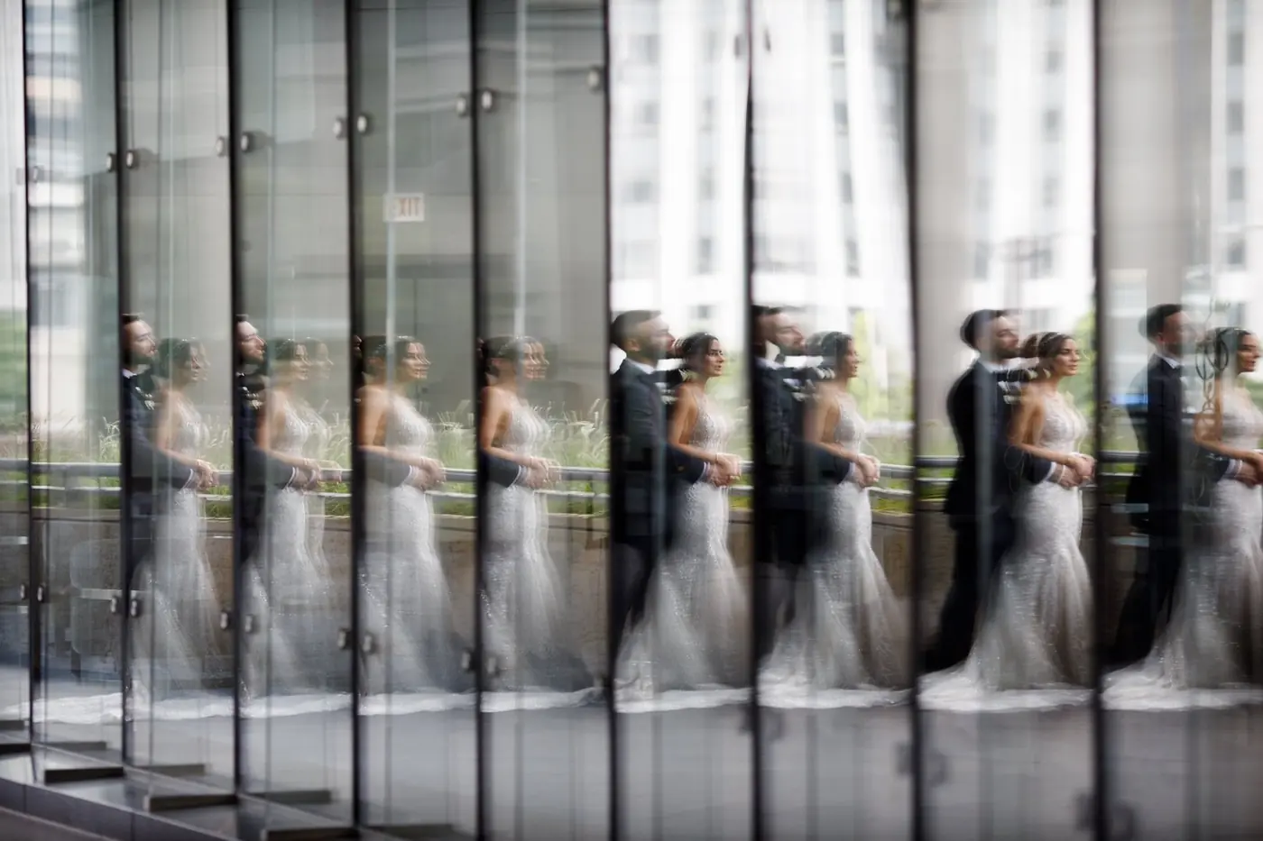 Alexis and Michael reflected in glass outside their Chicago wedding