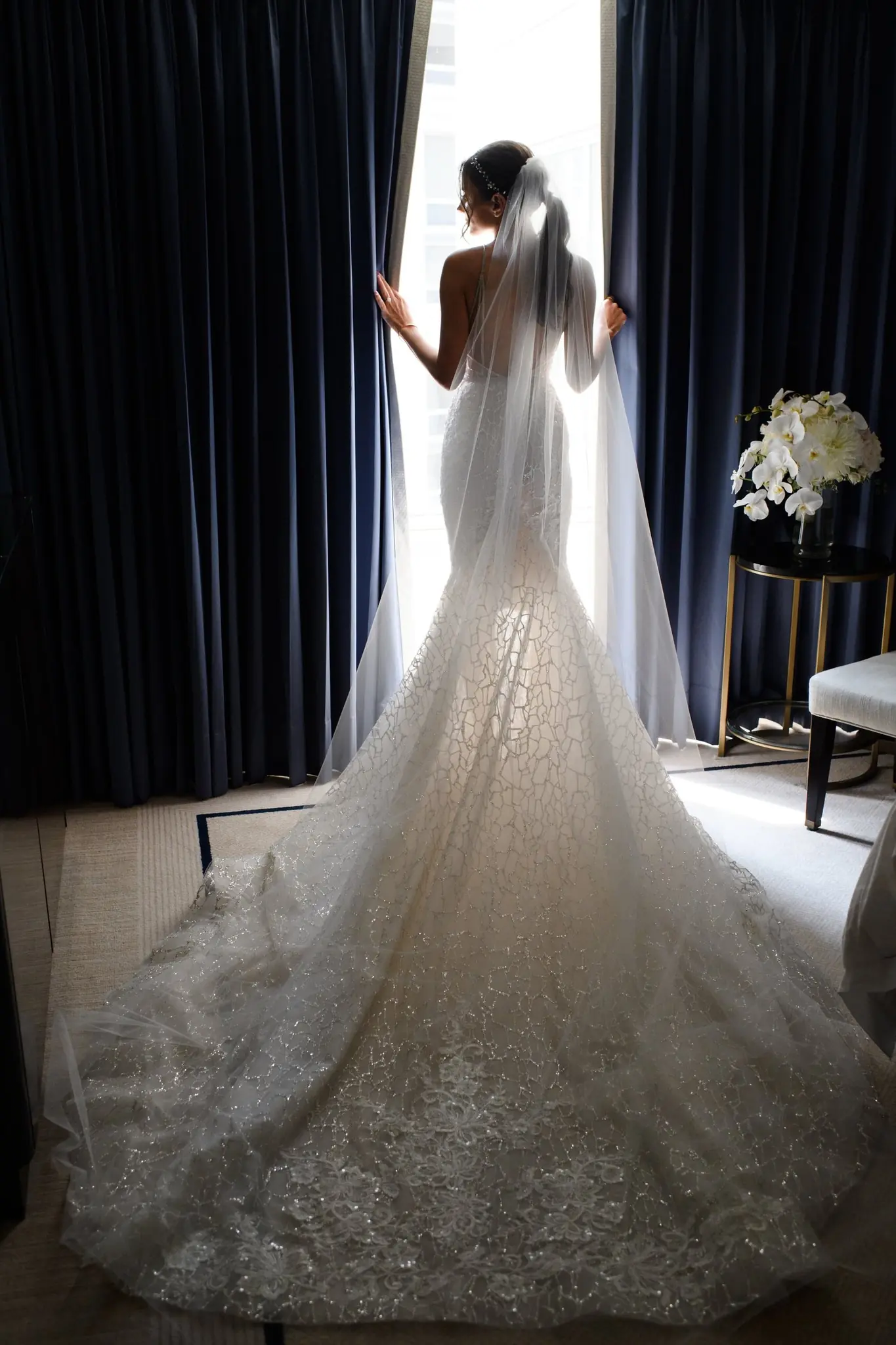 Alexis at the window in her Berta gown before the Peninsula Chicago wedding