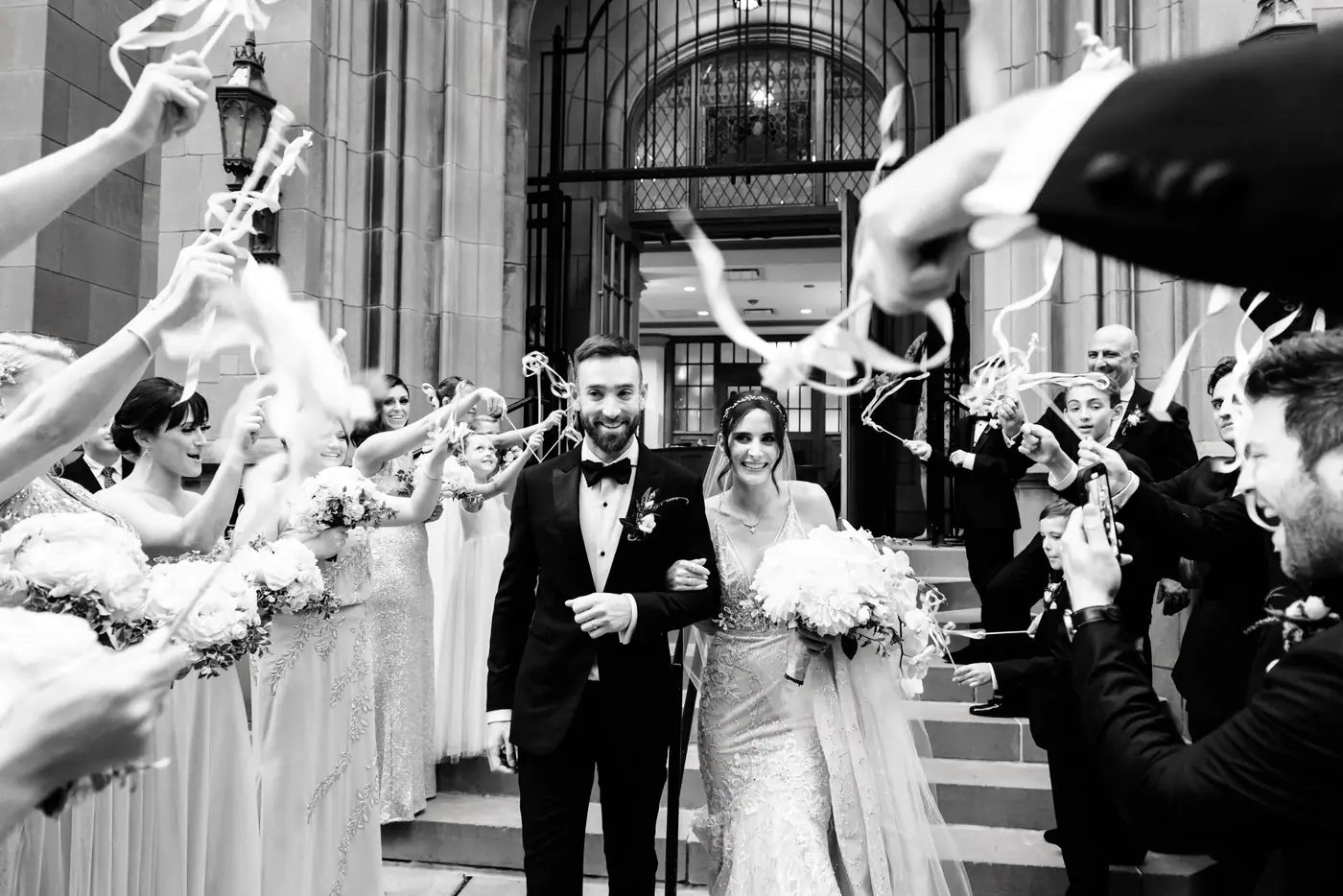 Alexis and Michael's ribbon-wand exit after their Saint James Chapel ceremony