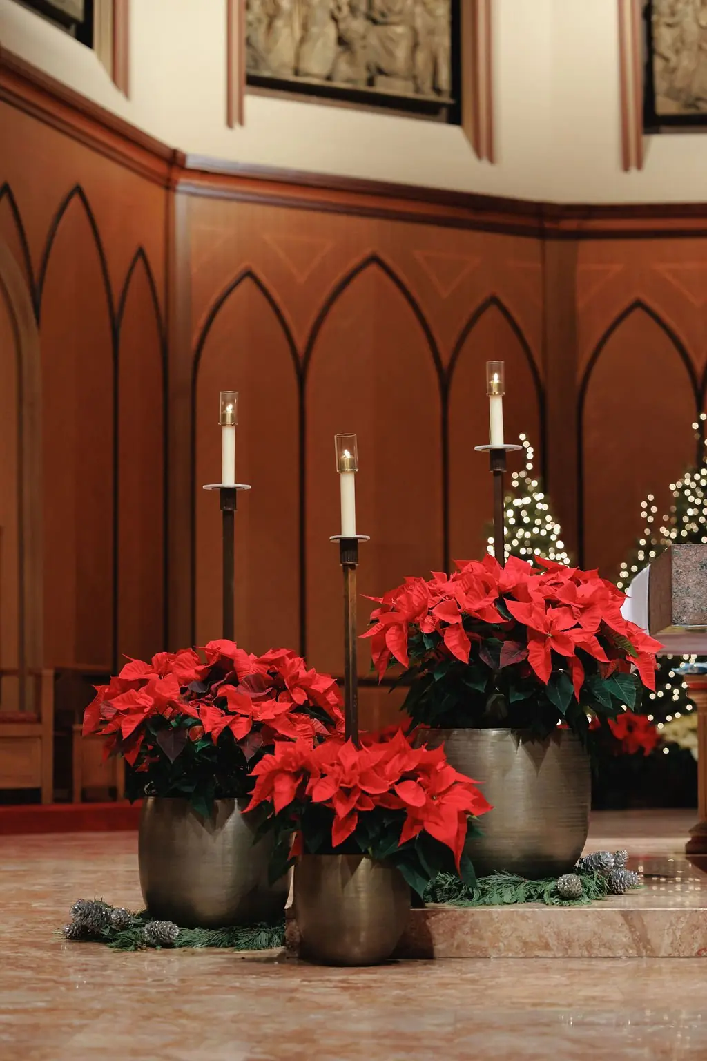 Poinsettia and candle altar decor at Jackie and Joe's Holy Name Cathedral ceremony