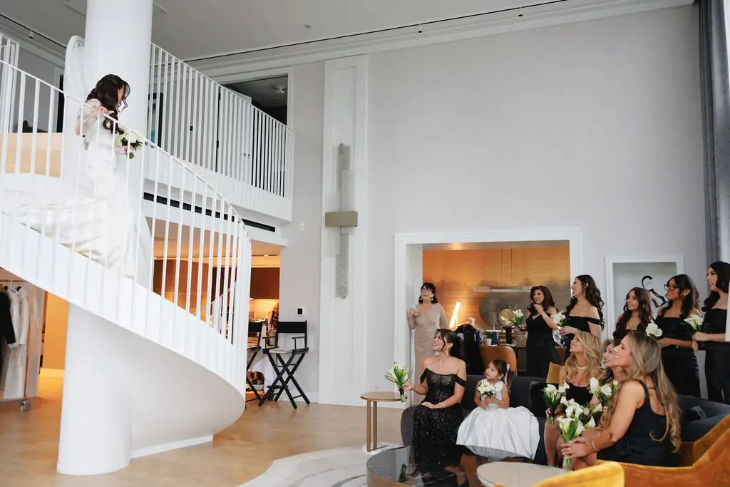 Jackie descending the staircase with her bridal party