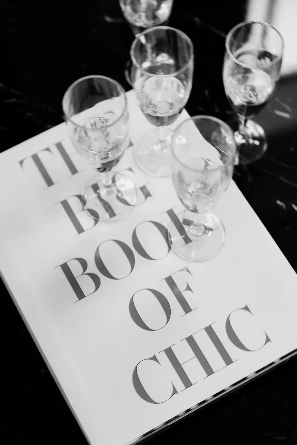 The Big Book of Chic beside champagne coupes at Jackie and Joe's Ritz-Carlton Chicago wedding