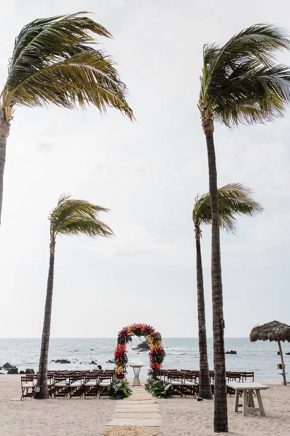 Gold place setting and tropical florals at Jean and Jennifer's reception
