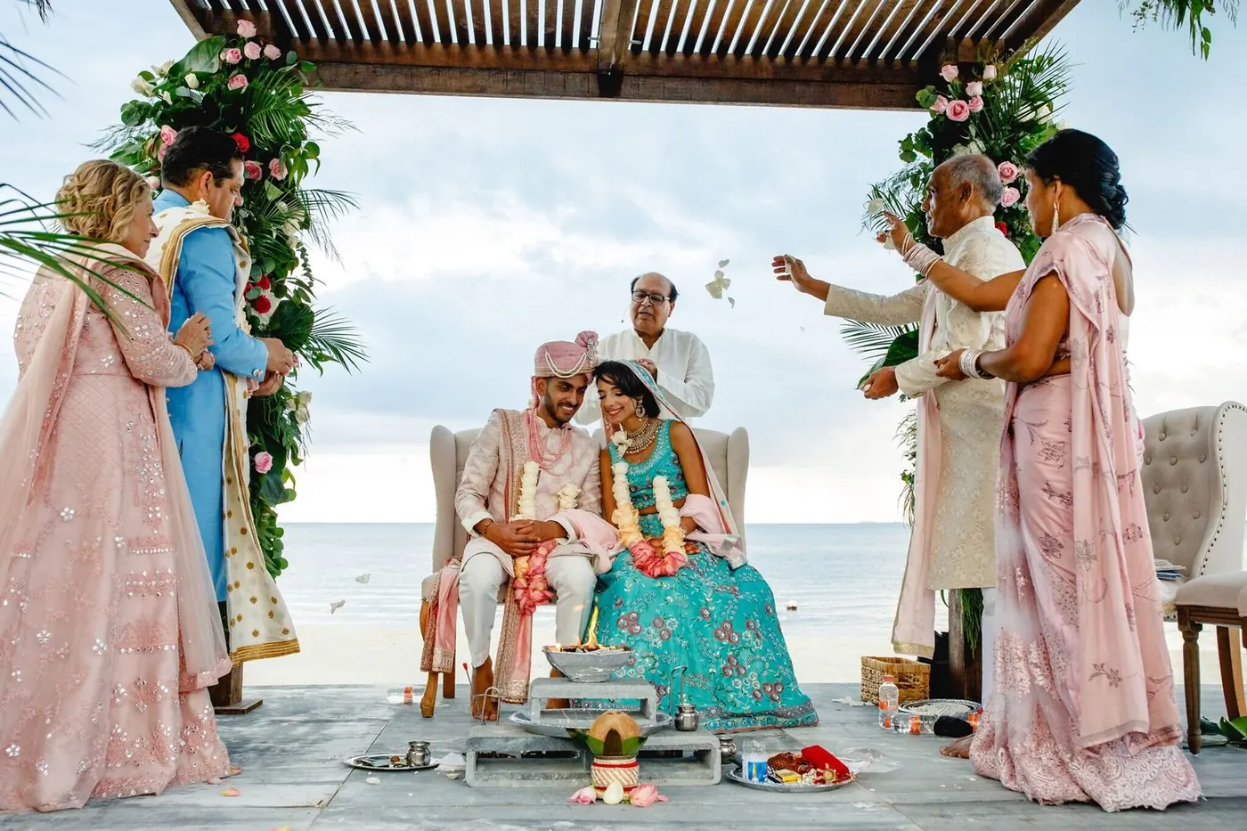 Hindu beach ceremony for Lara Sofia and Atul with family under the floral mandap
