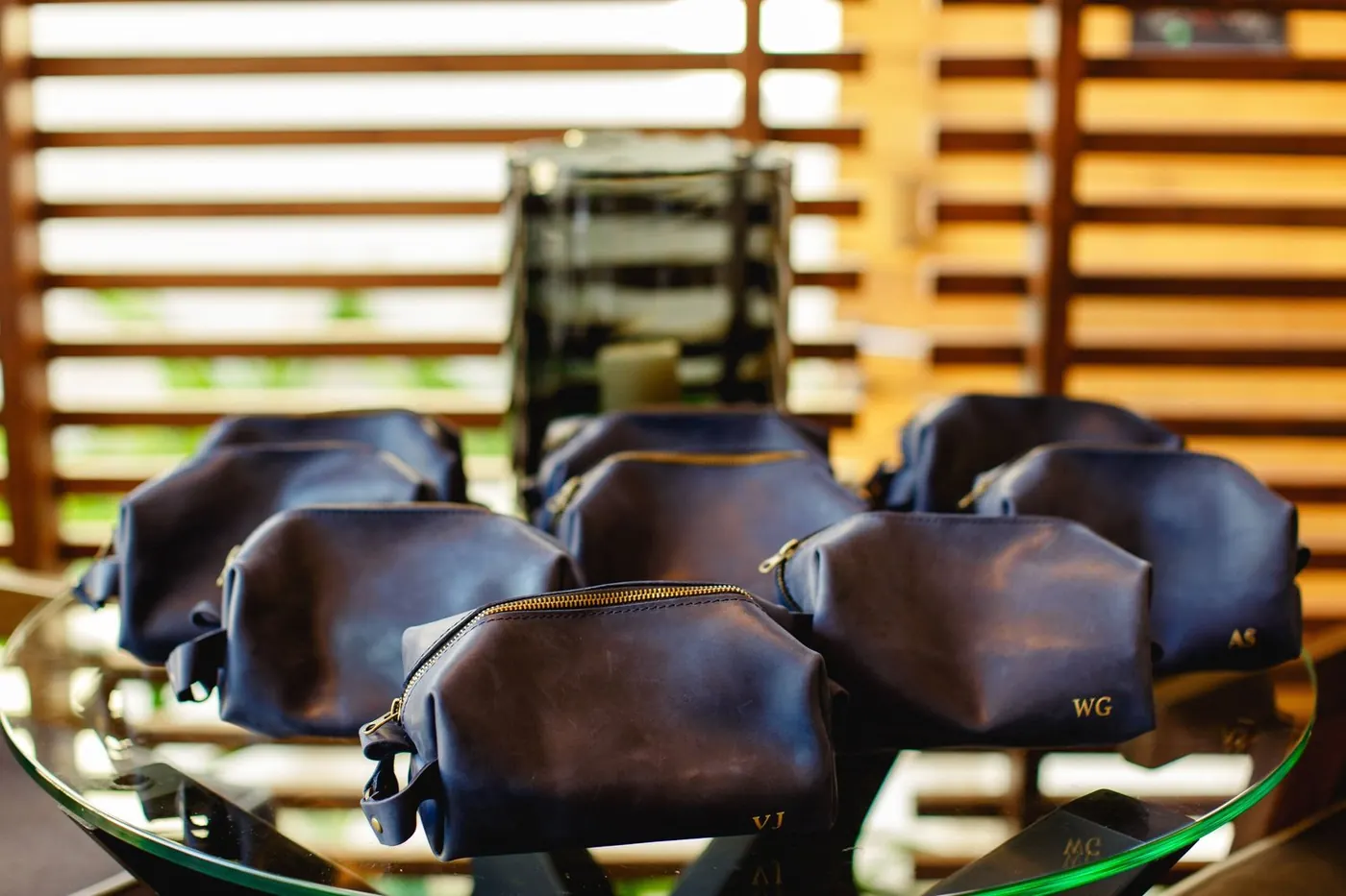Personalized navy leather toiletry bags for Lara Sofia and Atul's wedding guests