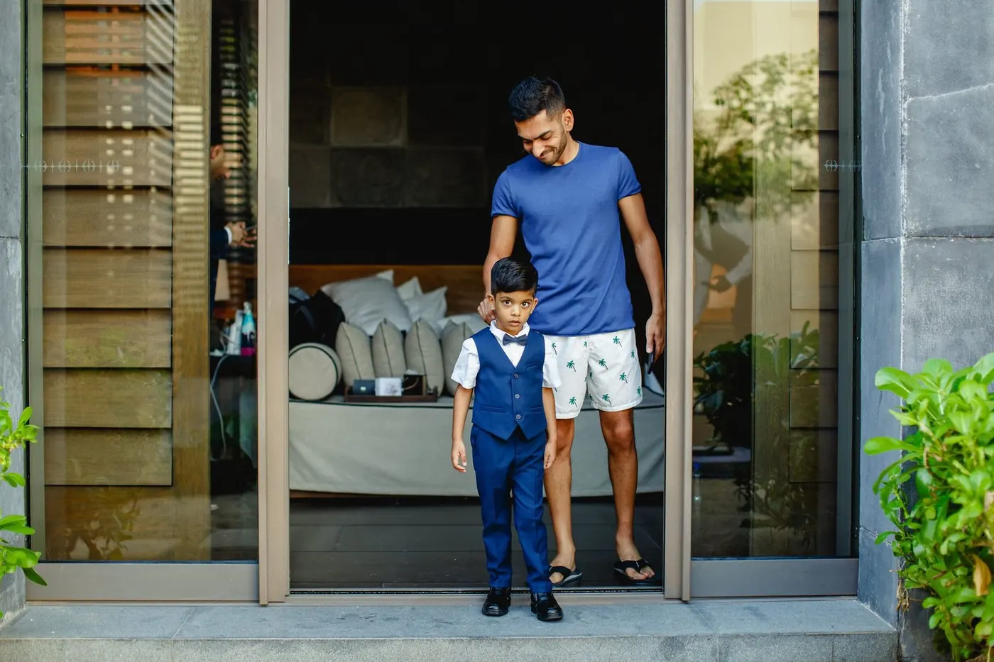 Atul with a young ring bearer in a navy suit at NIZUC