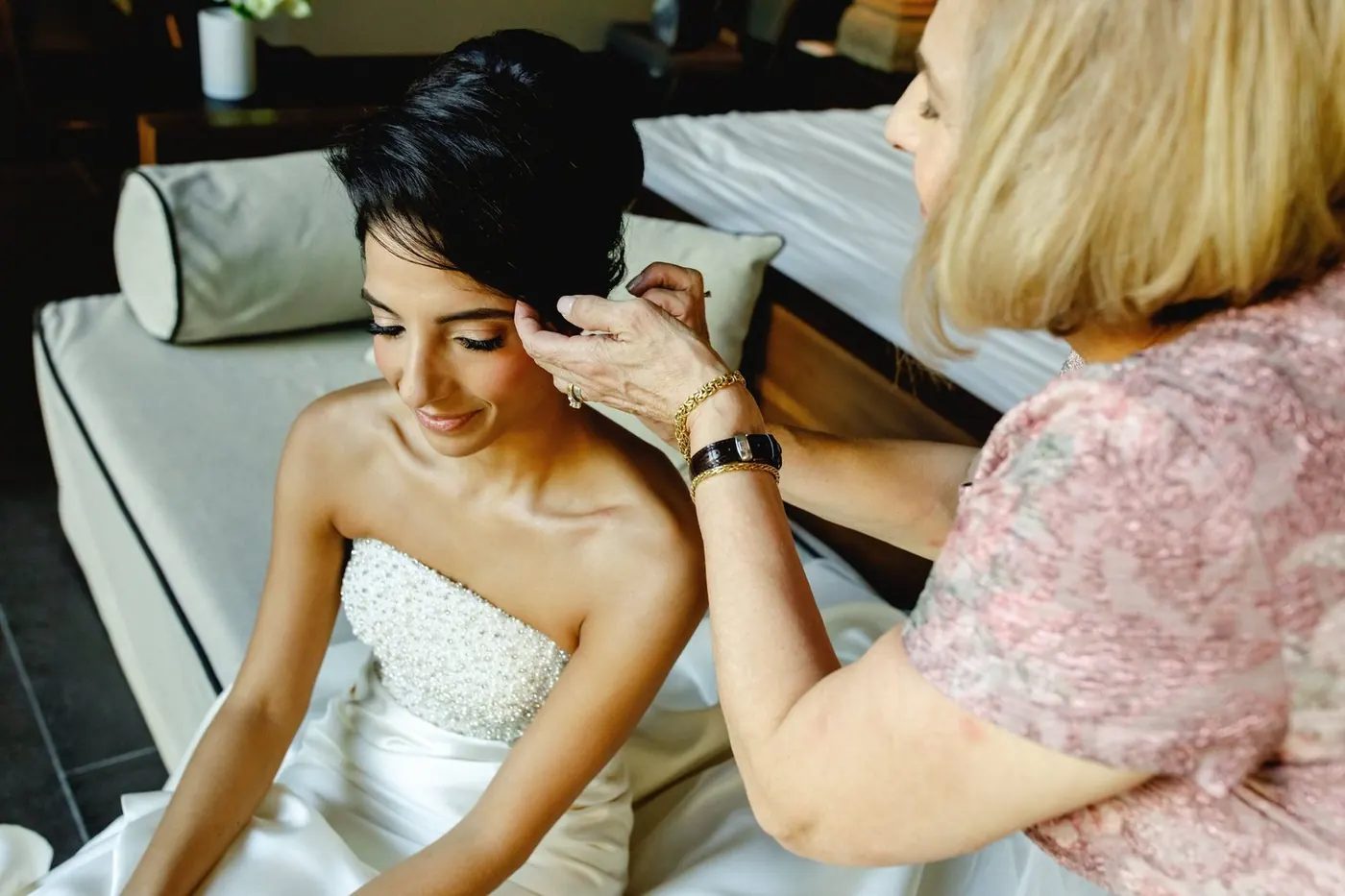 Lara Sofia getting ready as earrings are fastened before the ceremony