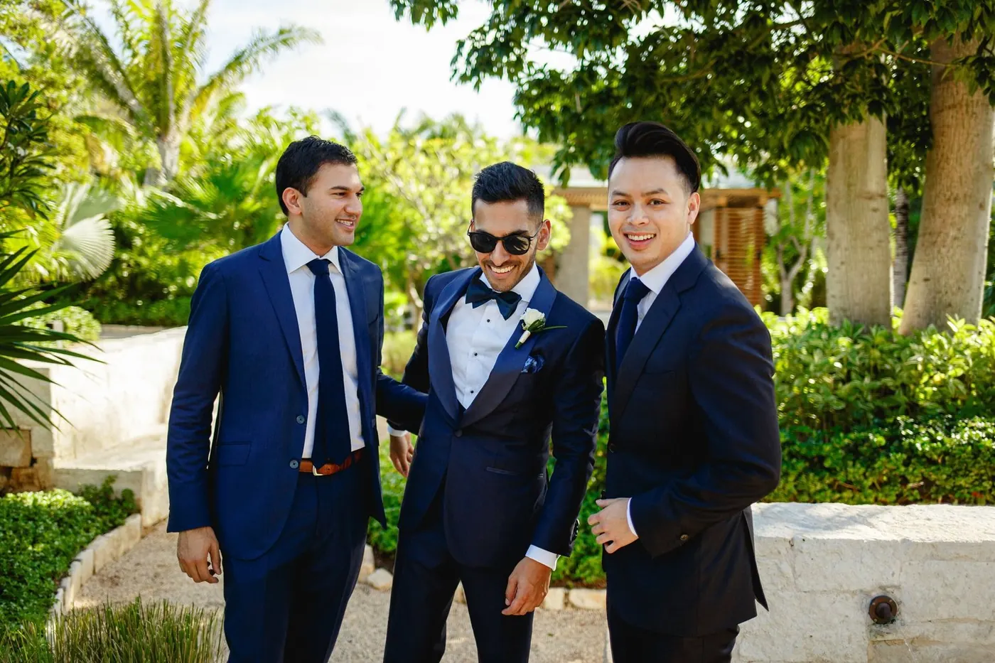 Atul and groomsmen in navy suits outdoors at NIZUC