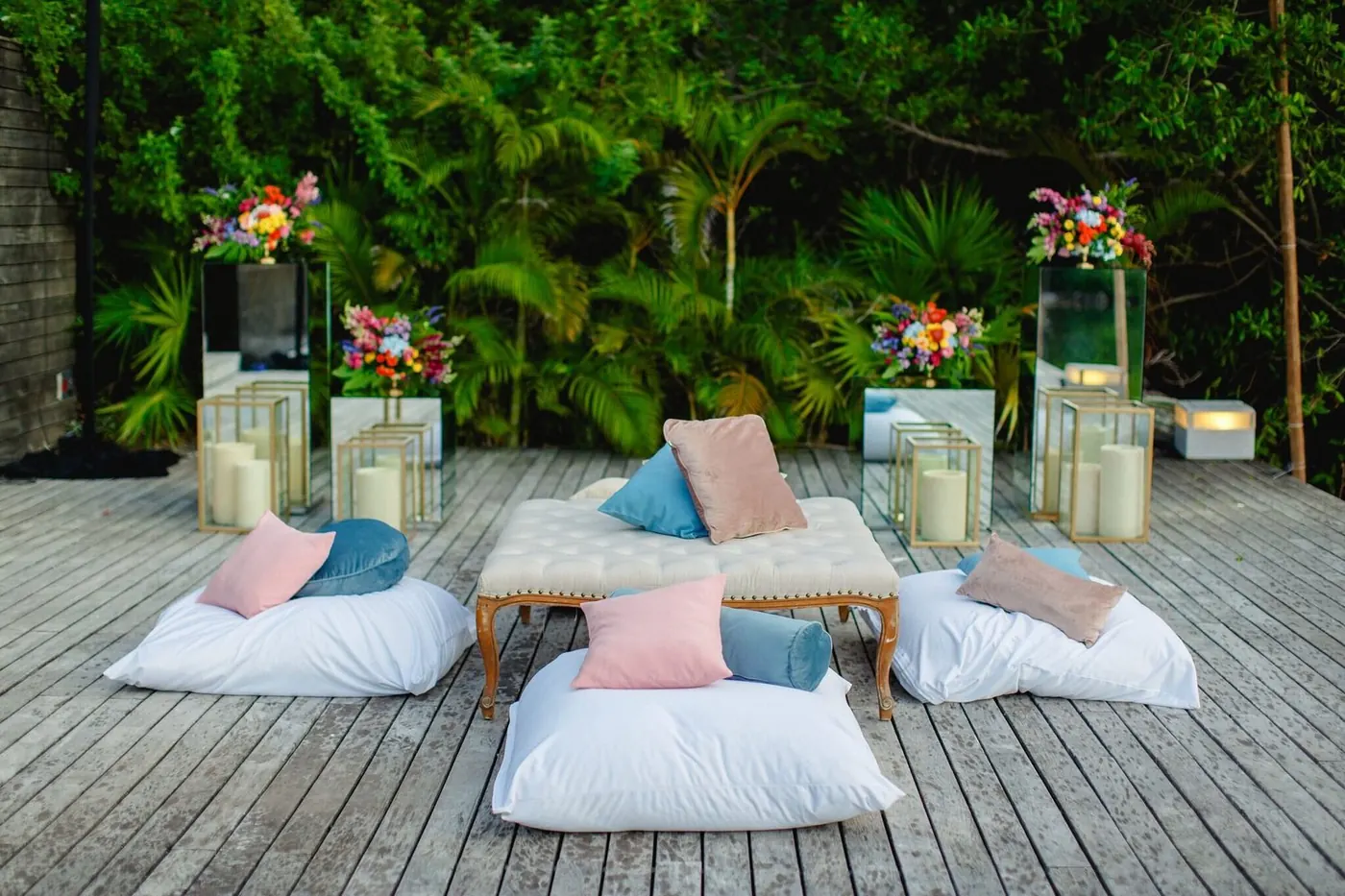Outdoor lounge seating with florals and lanterns on the deck at NIZUC