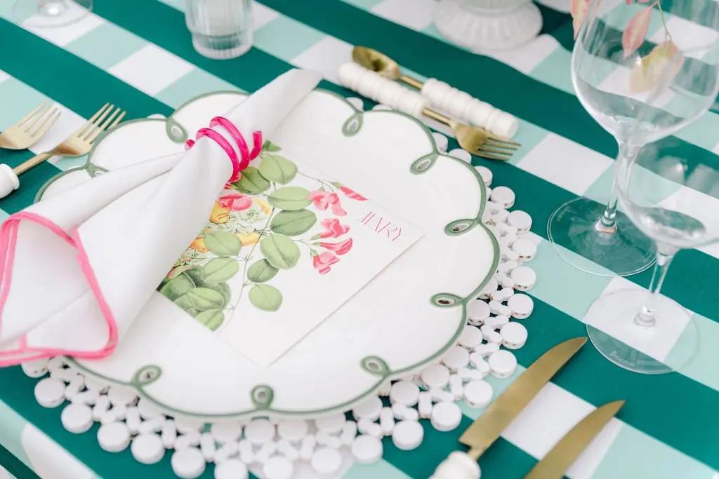 Place setting with green check linens at Lisa and Matt's Shoreacres vow renewal