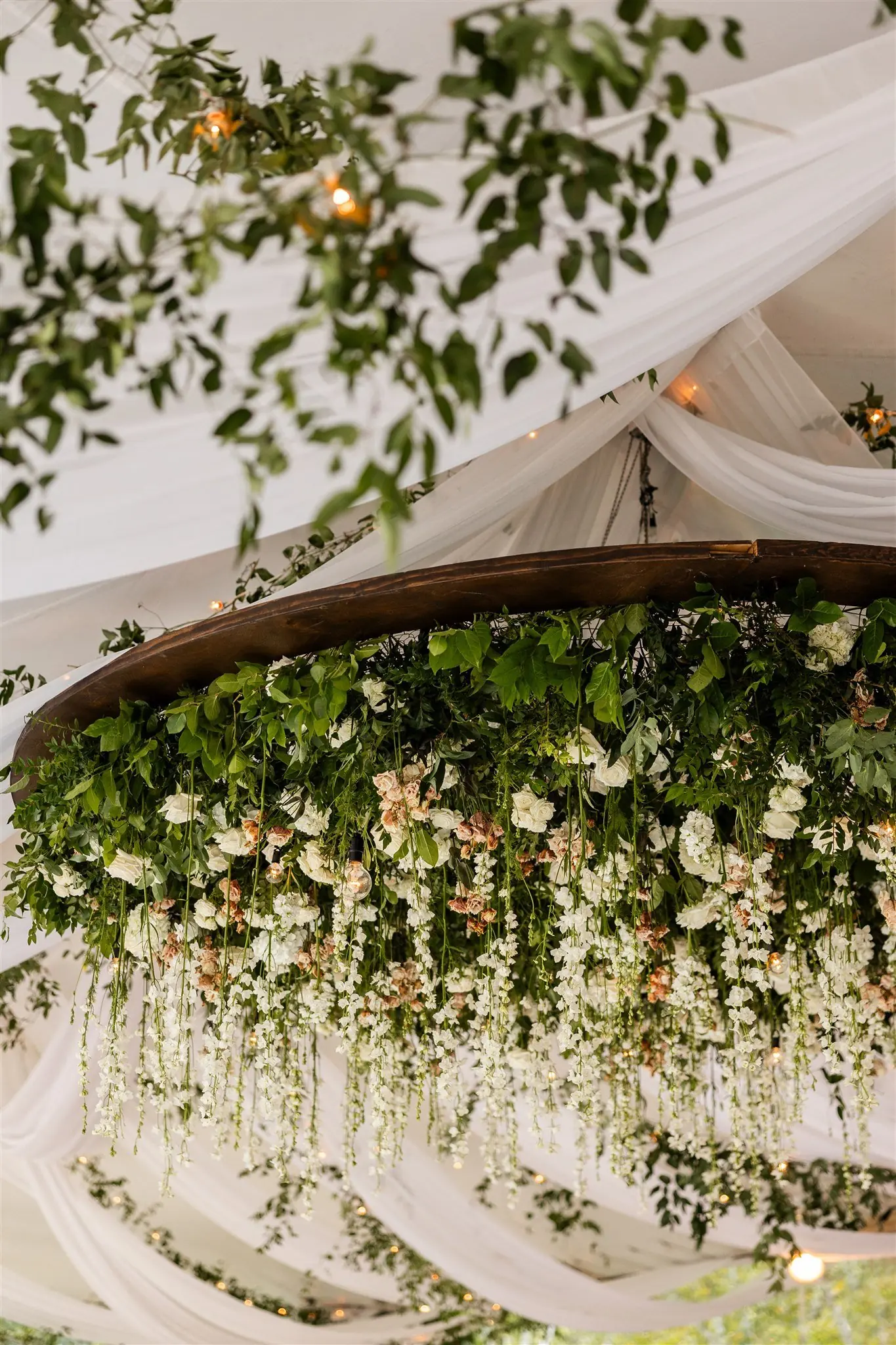 Hanging floral chandelier installation at Megan and Alex's reception