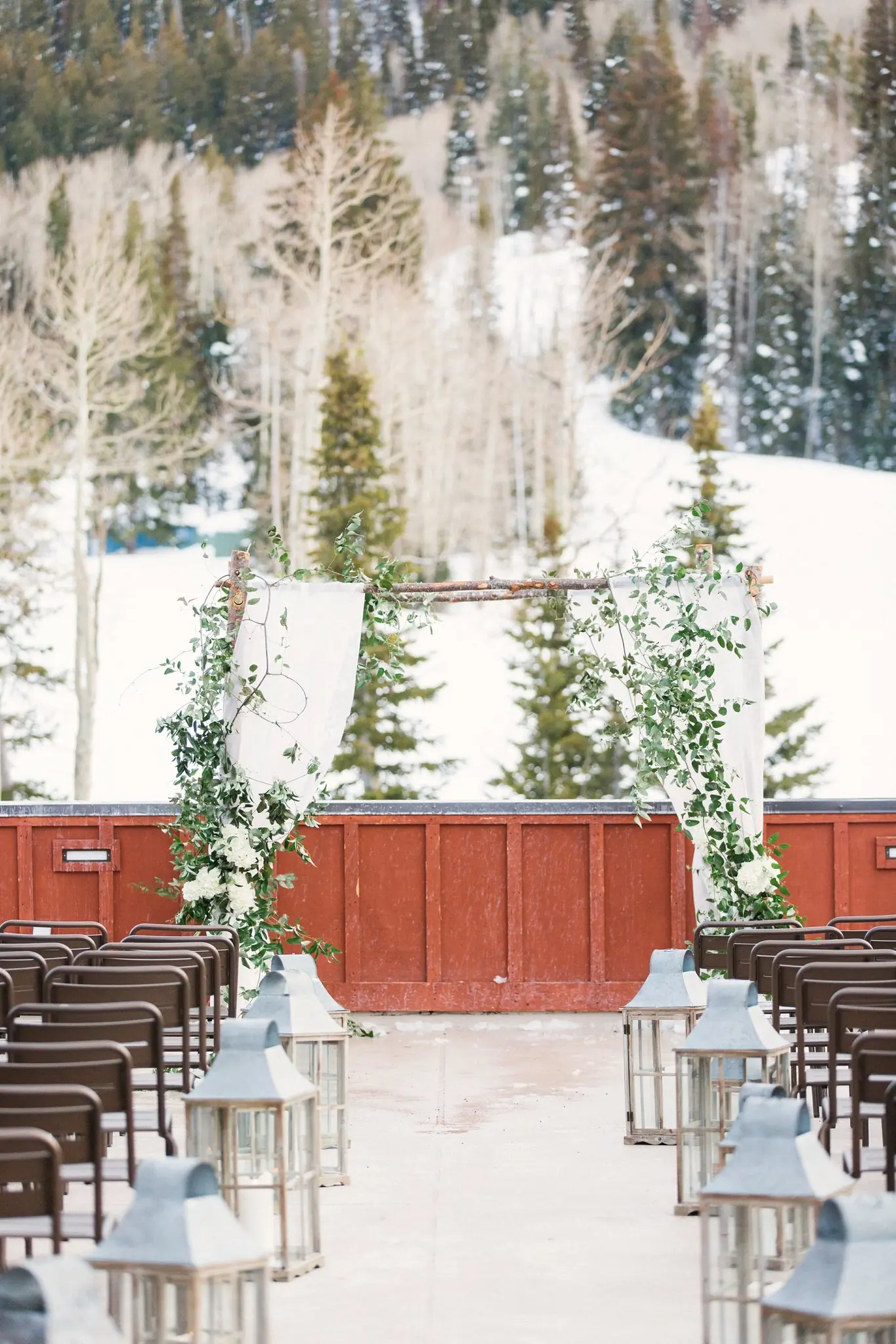 Snowy mountain ceremony arch for Rian and Matt at Red Pine Lodge