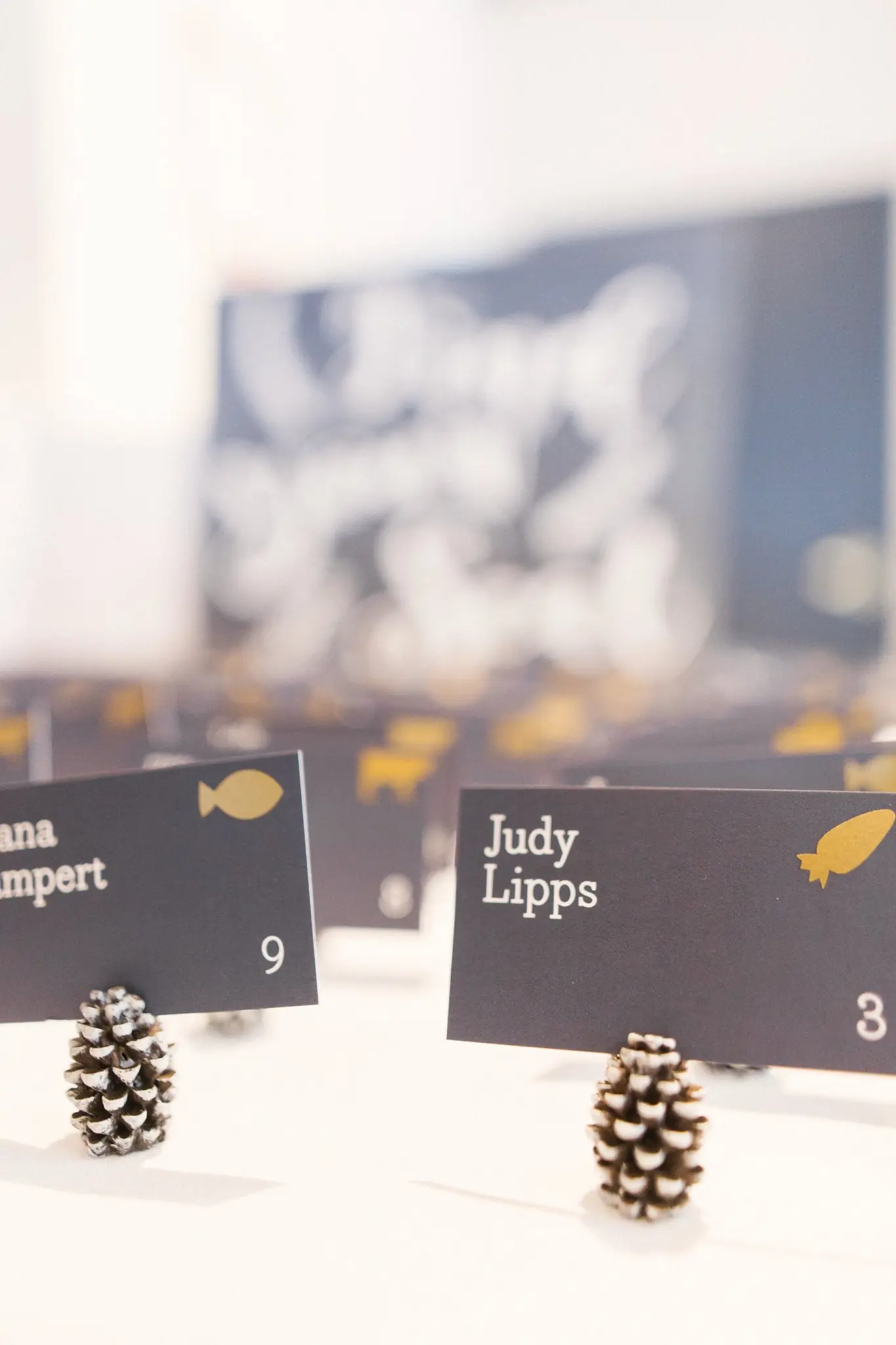 Navy place cards in silver pinecones for Rian and Matt's reception