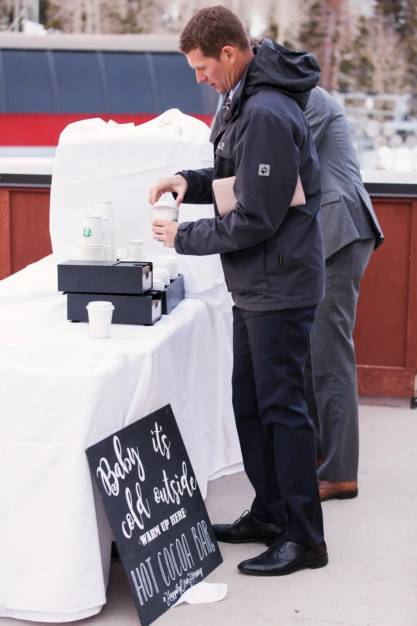 Hot cocoa bar welcoming guests at Rian and Matt's winter wedding