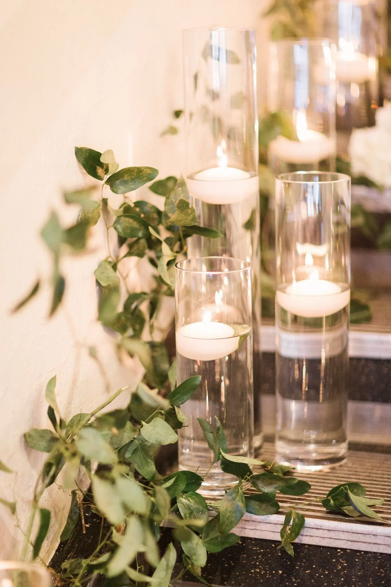 Floating candles and greenery on the staircase at Rian and Matt's celebration